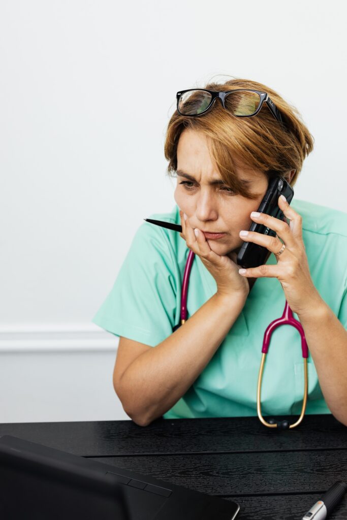 Doctor looking at confused at a desk in front of computer